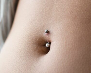 how long does it take for a belly button piercing to heal before swimming